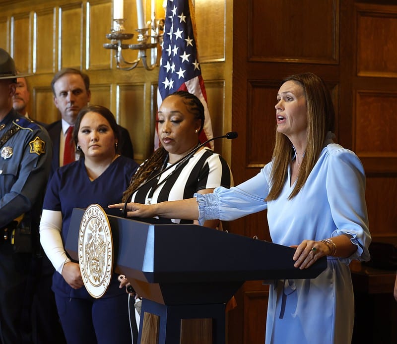Gov. Sarah Huckabee Sanders (right) announces a new state employee pay plan as Department of Human Services employee, Santresa Jackson (center) of Conway, and Dakota Moore (left), a nurse at the Sevier County Health Department in DeQueen, look on during a press conference on Tuesday, Nov. 12, 2024, at the state Capitol in Little Rock. Sanders said Jackson and Moore’s positions were two that would receive pay raises with her new plan. .(Arkansas Democrat-Gazette/Thomas Metthe)